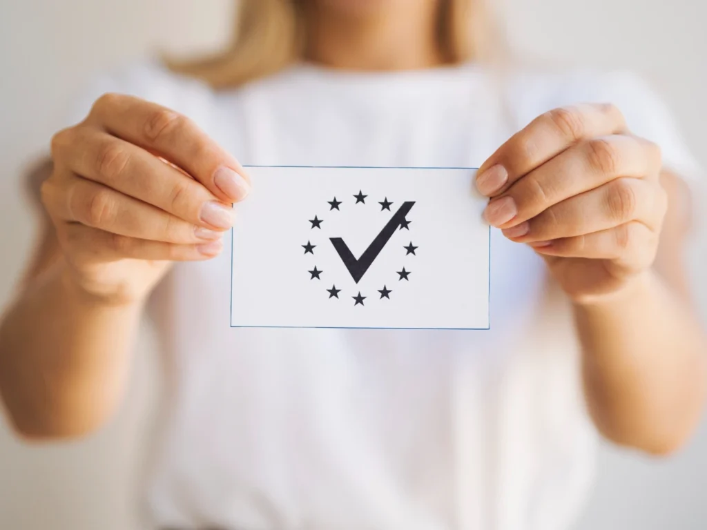 a person holding a card with a check mark and stars